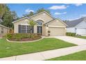 Well-maintained home with a two-car garage, lush lawn, and neatly trimmed landscaping at 9545 Southern Garden Cir, Altamonte Springs, FL 32714