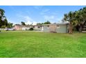 Inviting single-story home with manicured lawn, stone accents, and well-lit facade at 1108 Jordan Ave, Orlando, FL 32809