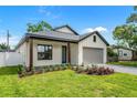Beautiful exterior with nice landscaping, gray brick driveway, neutral colors, modern design, and covered front porch at 1109 Naples Dr, Orlando, FL 32804
