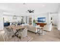 Bright open-concept living room features modern furnishings, adjacent kitchen with white cabinetry and an eat-in island at 1109 Naples Dr, Orlando, FL 32804