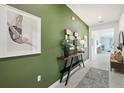 Bright entryway featuring a console table with decor and a tiled floor at 1240 Blue Daze Ln, Eustis, FL 32726