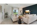 Cozy living room with neutral decor, plush seating, and access to the backyard at 1240 Blue Daze Ln, Eustis, FL 32726