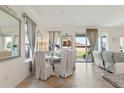Bright dining area with tile flooring, modern decor, and sliding door access to backyard at 125 Silver Maple Rd, Groveland, FL 34736