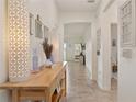 Inviting hallway features neutral walls, tiled floor, and tasteful decor, creating a warm and welcoming ambiance at 125 Silver Maple Rd, Groveland, FL 34736