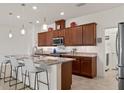 Beautiful kitchen with granite countertops, wood cabinets, a spacious island, and modern stainless steel appliances at 125 Silver Maple Rd, Groveland, FL 34736