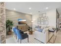 Comfortable living room with modern decor, shiplap wall, and ample seating at 1251 Blue Daze Ln, Eustis, FL 32726