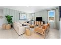 Inviting living room with stylish decor, comfortable seating, and abundant natural light streaming through the windows at 1252 Blue Daze Ln, Eustis, FL 32726