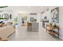 Open-concept living space with a modern kitchen, dining area, and cozy living room, perfect for entertaining at 1252 Blue Daze Ln, Eustis, FL 32726