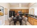 A lovely dining table sits in this kitchen/dining combo with oak cabinets and black appliances at 128 Brushcreek Dr, Sanford, FL 32771