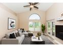 Bright living room with vaulted ceilings, and large windows for plenty of natural light at 128 Brushcreek Dr, Sanford, FL 32771
