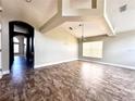 Large living room showing high ceilings, tile floors, ceiling beams, neutral paint and open floor plan at 128 Brushcreek Dr, Sanford, FL 32771