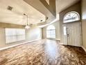 Bright living room with high ceilings, tile floors, and large arched window letting in natural light at 128 Brushcreek Dr, Sanford, FL 32771