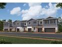 Charming row of modern townhouses with gray siding, stone accents, and attached garages at 14938 Harvest St, Orlando, FL 32824