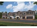 Charming row of modern townhouses with gray siding, stone accents, and attached garages at 14938 Harvest St, Orlando, FL 32824