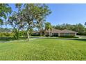 Well-maintained single story home with a spacious front yard at 15305 Shady Ln, Tavares, FL 32778