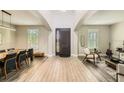 Spacious foyer with high ceilings, wood-look tile flooring, and ample natural light from the front windows at 15465 Heron Hideaway Cir, Winter Garden, FL 34787