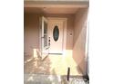 Welcoming front door with sidelights and tile flooring on a covered porch at 1621 Emily Ct, Kissimmee, FL 34744