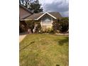 Charming home featuring a large arched window and well-maintained front yard landscaping at 1621 Emily Ct, Kissimmee, FL 34744