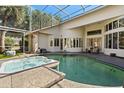 Sparkling pool and spa in screened enclosure offer a private backyard retreat at 2241 Lake Vilma Dr, Orlando, FL 32835