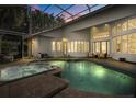 Backyard pool and spa in screened enclosure, perfect for outdoor relaxation and entertaining at 2241 Lake Vilma Dr, Orlando, FL 32835