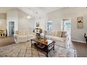 Bright living room featuring neutral colors, comfortable seating, and a stylish area rug at 2302 Edmonton Ct, Clermont, FL 34711