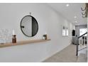Well-lit hallway with a shelf, mirror, and stylish decorations at 2382 Zaballina Pl, Kissimmee, FL 34747