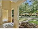 Inviting covered porch showcasing views of the street, manicured landscaping, and neighboring townhomes at 2460 Formax Dr, Orlando, FL 32828