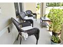 Inviting front porch featuring cozy wicker seating and potted plants, perfect for relaxing at 2524 Harmonia Hammock Rd, Harmony, FL 34773