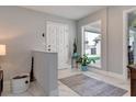 Bright foyer with a white front door, marble floors, and a large window showcasing backyard views at 2803 Tech Dr, Orlando, FL 32817