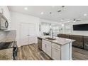 Modern kitchen featuring a kitchen island, stainless steel appliances, granite countertops, and open-concept layout at 292 Spirit Landings Cir, Winter Haven, FL 33880