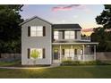 Inviting two-story home featuring a covered front porch ideal for relaxing evenings and a manicured lawn at 32615 Windy Oak St, Sorrento, FL 32776