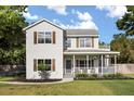 Attractive two-story home with a covered front porch, perfect for enjoying outdoor moments at 32615 Windy Oak St, Sorrento, FL 32776