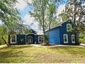 Charming blue home with mature trees and landscaping at 3441 Hickory Creek Rd, Deltona, FL 32738