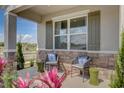 Inviting front porch with stone accents, decorative shutters, and cozy seating area at 3586 Dahlia Dr, Lake Hamilton, FL 33851