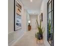 Elegant hallway featuring neutral colors, tile floors, and stylish decorations at 3586 Dahlia Dr, Lake Hamilton, FL 33851