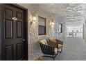 Hallway view with decorative wall texture, chairs, lighting and a glimpse of ocean view at 3747 S Atlantic Ave # 2050, Daytona Beach, FL 32118