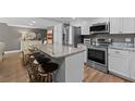 Kitchen featuring white cabinets, stainless steel appliances, and a granite countertop island with seating at 3747 S Atlantic Ave # 2050, Daytona Beach, FL 32118