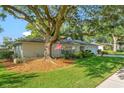 Charming single-story home with a well-maintained lawn and American flag at 4011 Teriwood Ave, Orlando, FL 32812