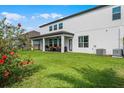 Large backyard with a covered patio, green grass, mature trees, and an exterior view of home at 408 Egret Place Dr, Winter Garden, FL 34787