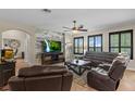 Stylish living room featuring a modern accent wall and comfortable leather seating at 408 Egret Place Dr, Winter Garden, FL 34787