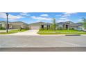A cozy home featuring a manicured lawn and a neatly paved driveway at 415 Overpool Ave, Davenport, FL 33896