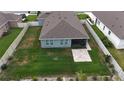 A spacious fenced backyard, perfect for outdoor activities, featuring a patio area extending from a screened-in porch at 449 Halter Dr, Apopka, FL 32712