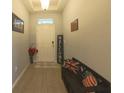 Inviting foyer featuring wood flooring, a welcome sign, and decorative pillows on a bench at 449 Halter Dr, Apopka, FL 32712
