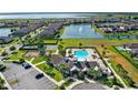 Aerial view of the Lakeshore community pool and playground with pond at 5006 Caspian St, St Cloud, FL 34771