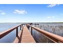 View of dock and water with boats tied to it, blue skies and a few clouds above at 5006 Caspian St, St Cloud, FL 34771