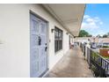 Apartment 6095 entrance with a decorative blue door and walkway at 6095 Village Cir # 6095, Orlando, FL 32822