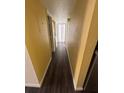 Hallway with wood look flooring leading to a bathroom at 710 Ridenhour Cir # 710, Orlando, FL 32809