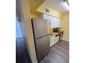 Well-lit kitchen features modern stainless steel appliances and ample cabinet storage at 710 Ridenhour Cir # 710, Orlando, FL 32809