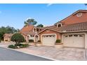 Charming townhome with terra cotta exterior, tile roof, and attached garages showcase neighborhood appeal at 7449 Sugar Bend Dr # 7449, Orlando, FL 32819