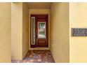 Elegant front door with glass detailing and address plaque, creating a welcoming entrance at 7519 Marker Ave, Kissimmee, FL 34747